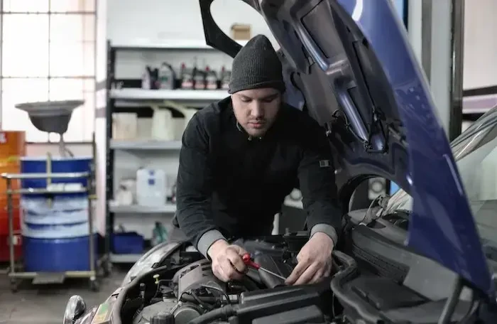  man repairing car small