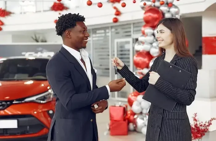  car dealer handing over the car keys small