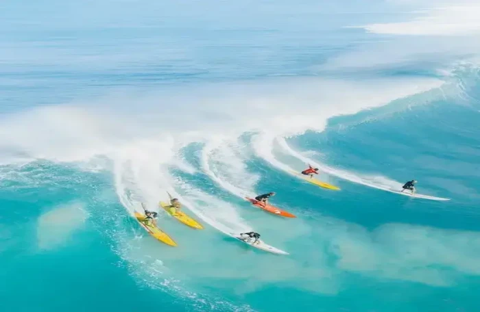  people surfing on sea waves small