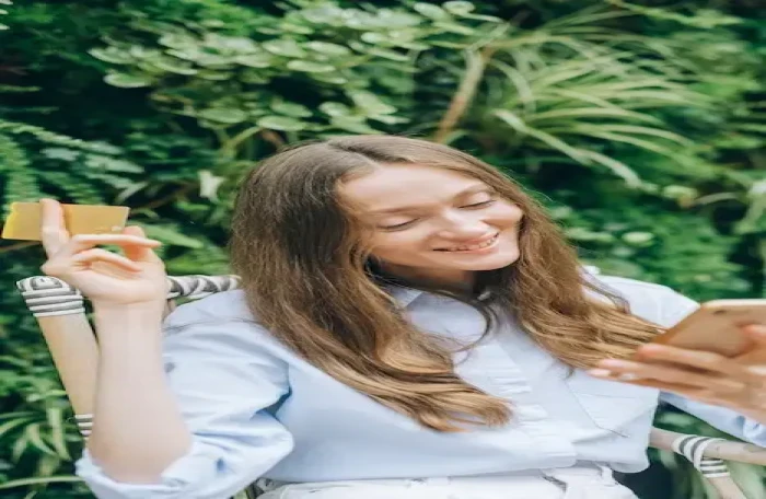  woman holding her phone and a credit card small