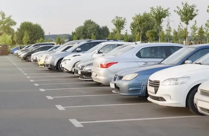  cars parking lot evening light sun small