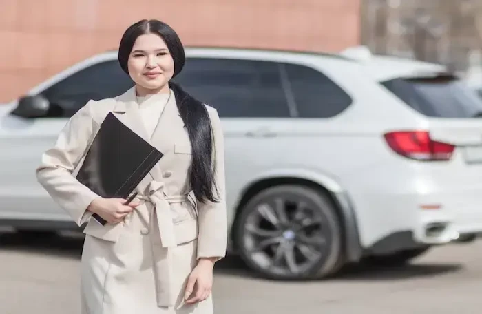  woman in beige corporate clothes holding black folder small