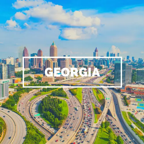 An aerial view of the Atlanta skyline with the word Georgia in bold white letters in the center.