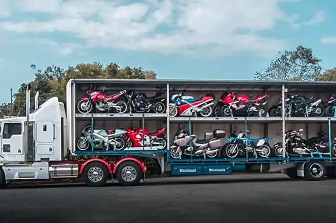 A semi-truck loaded with several motorcycles