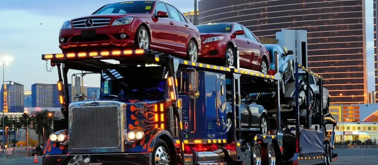 A car carrier truck loaded with several cars.