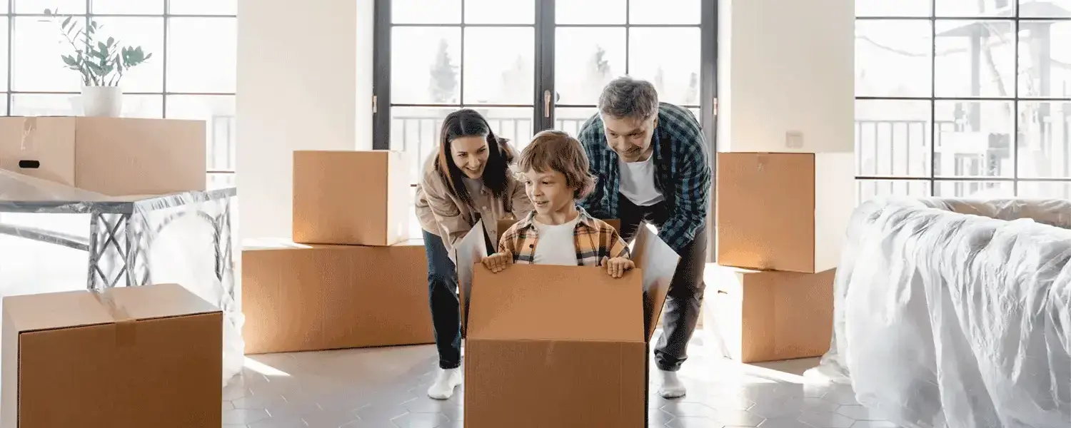 An image of a family, possibly unpacking boxes from their move.