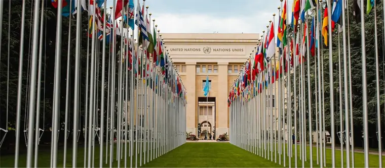 An image of flags in front of United Nations building.